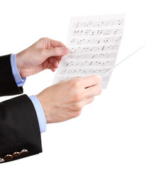 Fototapeta premium Music conductor hands with baton and notes isolated on white