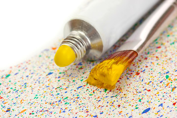 brushes with colorful paint and tube with watercolor
