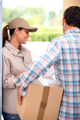 Man signing for a parcel at the front door