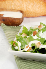 Cesar salad on green napkin
