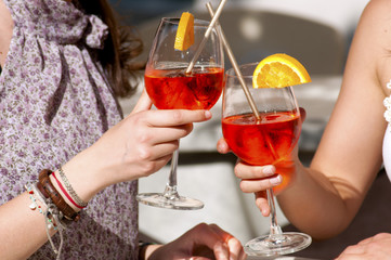 two young girls while they take a cocktail