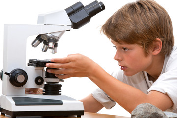 Young student working with microscope.