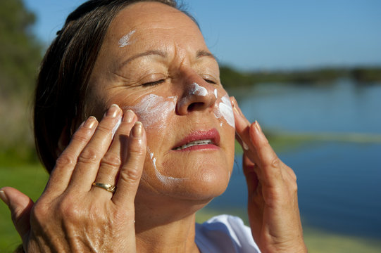 Happy Woman Sun Blocker On Face