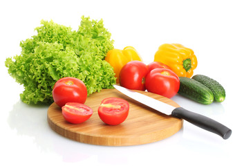 fresh vegetables and knife on cutting board isolated on white