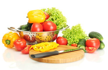 fresh vegetables and knife on cutting board isolated on white