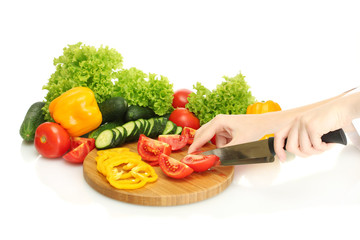 woman hands cutting vegetables on kitchen blackboard