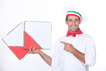 Chef pointing at pizza boxes