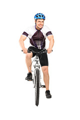 Obraz na płótnie Canvas Full length portrait of a male bicyclist posing on a bicycle