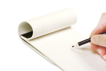 Pencil in hand writing on the notebook