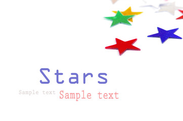 Christmas decoration of colored confetti stars against white bac