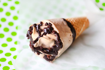 Homemade nougat ice cream with chocolate in a chocolate cone