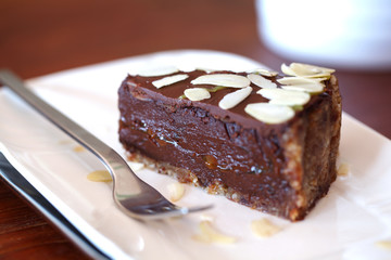 Raw chocolate cake with chocolate ganache and flaked almonds