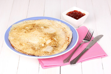 Stack of tasty pancakes on wooden background