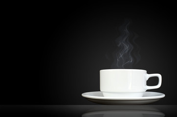 white cup with hot liquid and steam on black