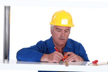 Tradesman using a measuring tape