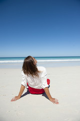 Relaxed woman sitting at remote tropical beach