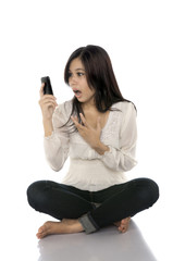 Fototapeta premium Asian Woman Shock See Her Cellphone