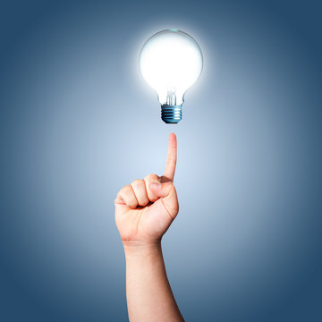 Hand pointing to Light bulb. Concept for new ideas
