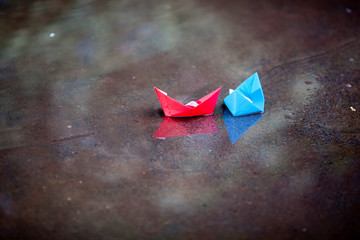 paper ship in the puddle