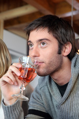 Young man with a glass of rose wine