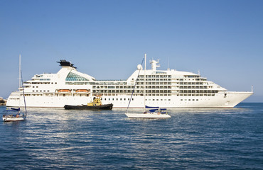 Fototapeta na wymiar Big cruise liner and little yachts