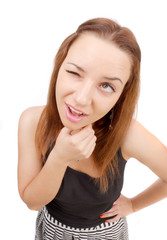 Fototapeta premium Pretty girl makes a grimace on his face on a white background.