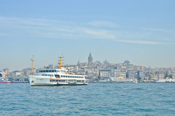 Fototapeta na wymiar White cruise ship in Bosporus with Galata Tower background
