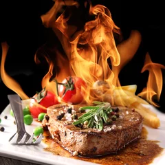 Papier Peint Lavable Steakhouse Grilled meat with fire flames