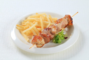 Pork skewer with French fries