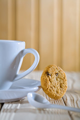 closeup composition. blue coffee cup with spoon and cookie