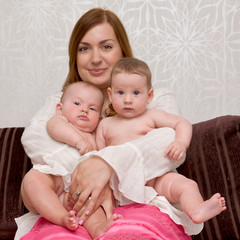 young mother with two adorable daughters twin babies girls