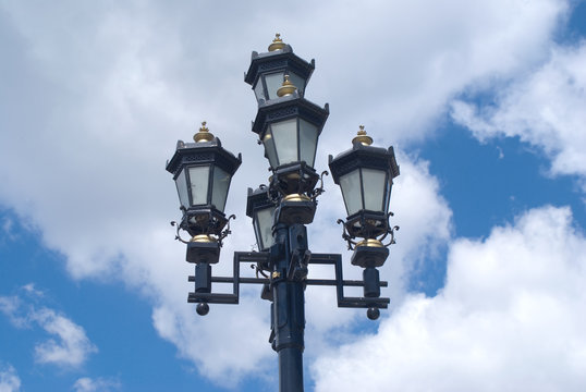 Retro styled lighting lantern over cloudy sky