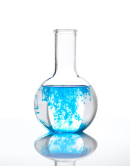 Chemical flask full of transparent liquid with a blue reagent