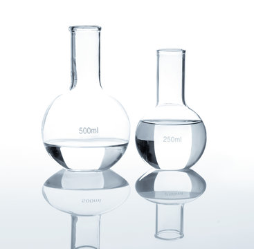 Empty laboratory flasks with a clear liquid, isolated