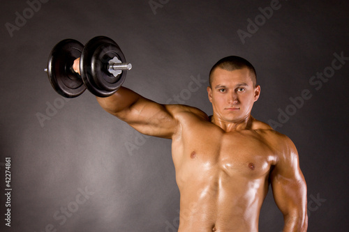 Muscled Male Bodybuilder Dumbbell Swing Stock Photo And