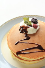 Berries and fresh cream on homemade pan cake