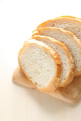 Slided french bread on wooden chopping board