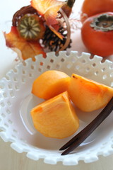 Autumn fruit, persimmon on dish