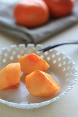 Autumn fruit, persimmon on dish