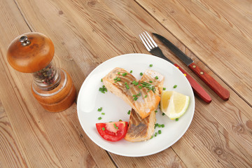 salmon fillet with cherry tomatoes and pepper grinder