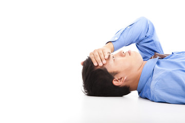 business man lying on floor with headache