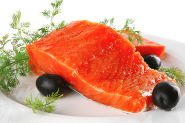 pink salmon on white plate with olives