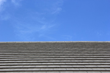 Roof tiles and blue sky on the background.