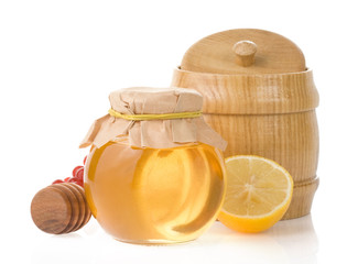 jar of honey and lemon isolated on white