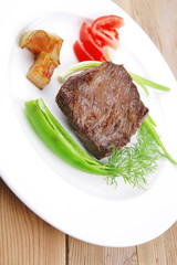 meat food : roasted fillet mignon on white plate with tomatoesan