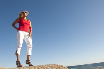 Confident, happy, sexy woman at ocean background