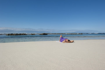 Sexy woman sunbathing at tropical beach
