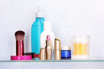 Shelf with cosmetics and toiletries in bathroom