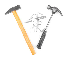 Hammers and metal nails isolated on white