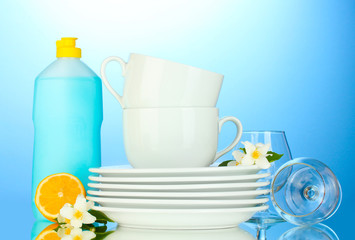 empty clean plates, glasses and cups with dishwashing liquid